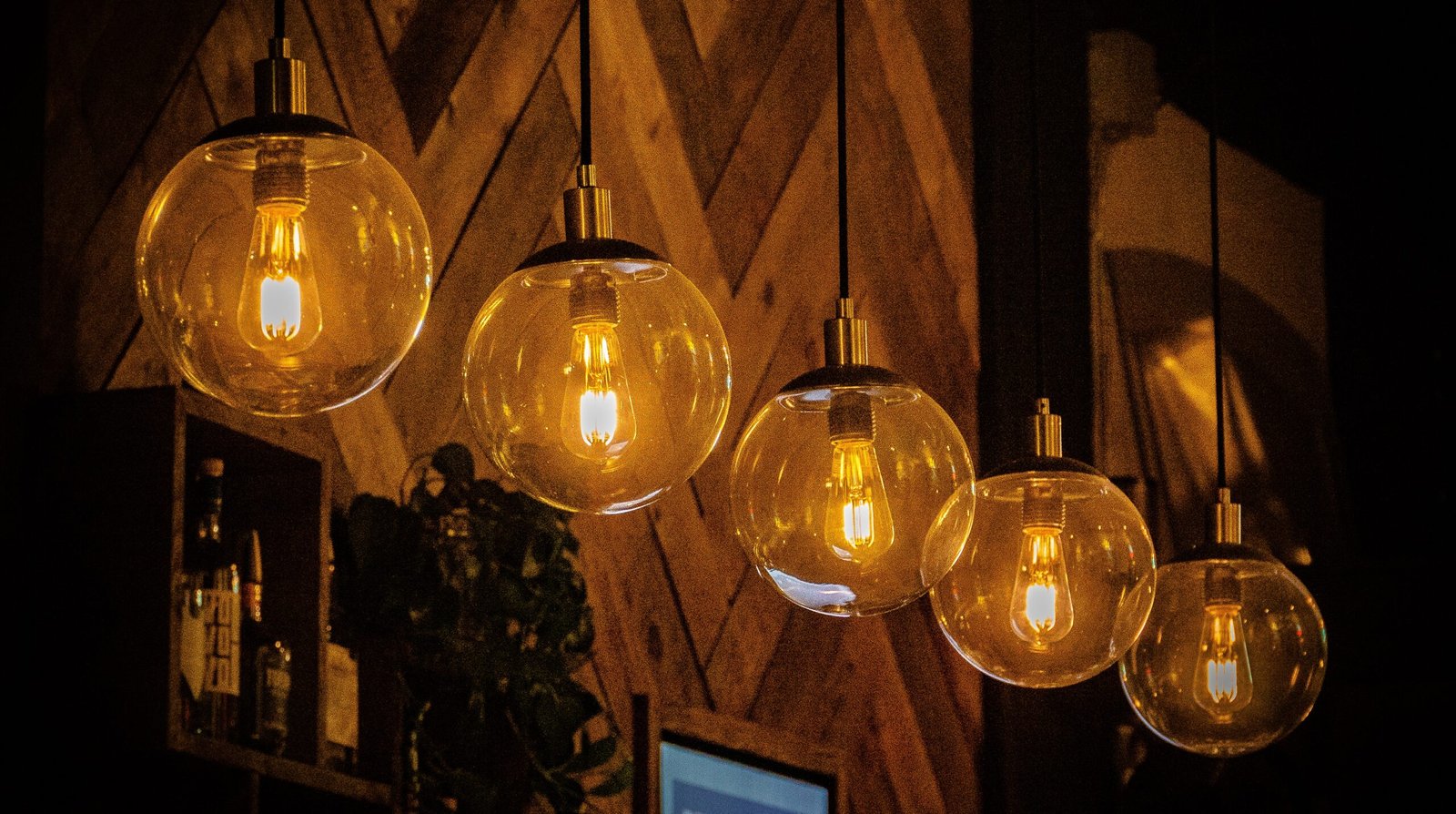 A row of decorative light bulbs hanging in a cafe